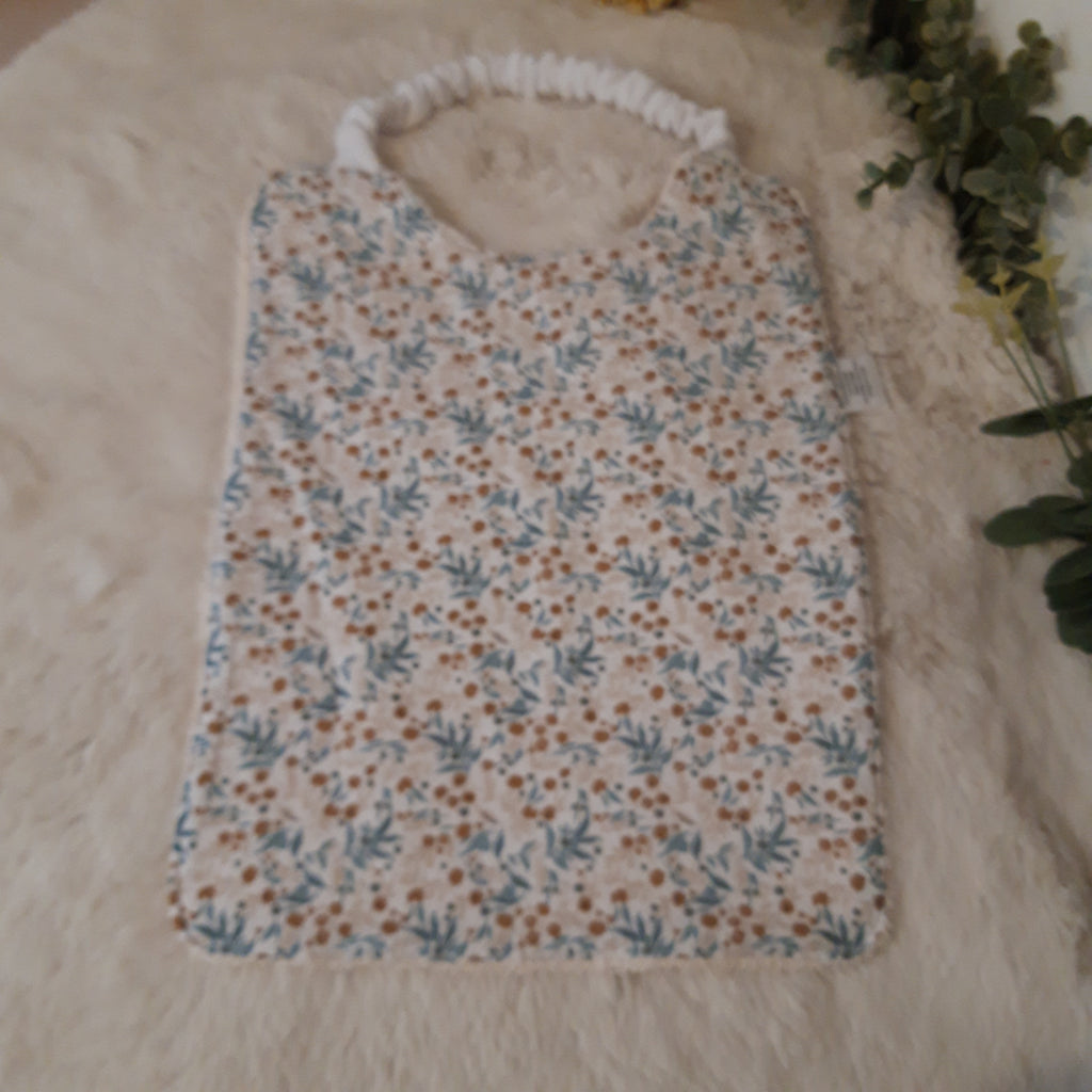 Bavoir élastique fleurs beiges et bleues