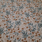 Bavoir élastique fleurs beiges et bleues